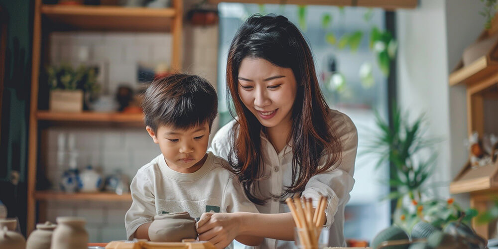 mom playing with boy with clay